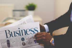 Businessmen in Canada reading newspaper