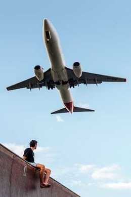 Man looking at a aircraft departure to Canada